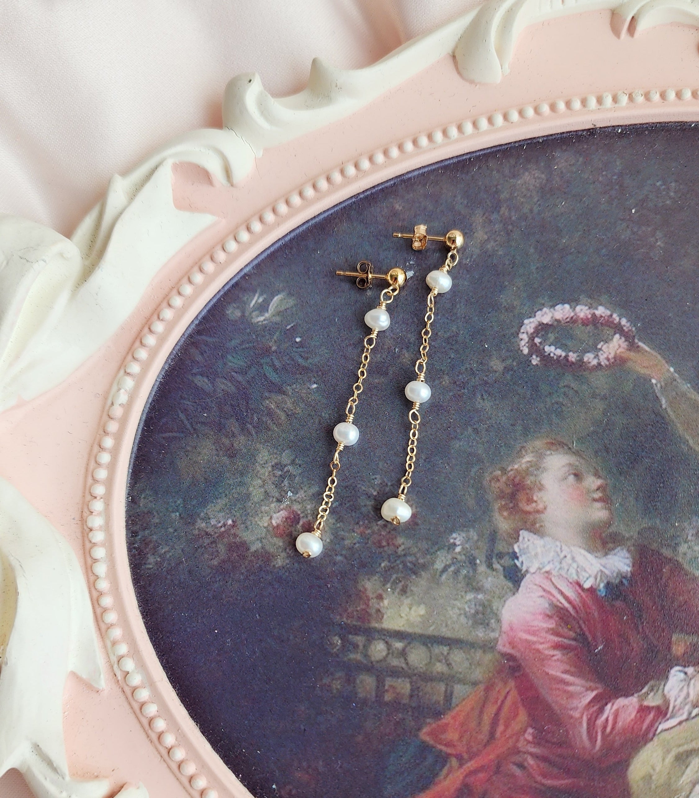 Top View Beautiful pearl dangly stud earrings for a bride and everyday client that wants dainty medium length earrings