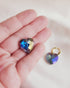 iridescent heart hoops in my hand for size reference