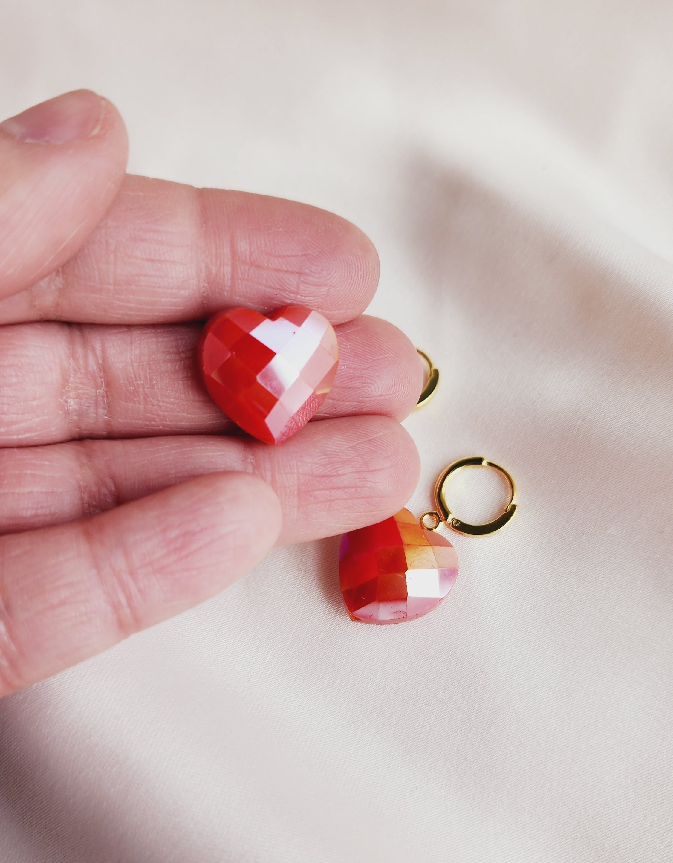 top view orange heart stones in my hand for reference