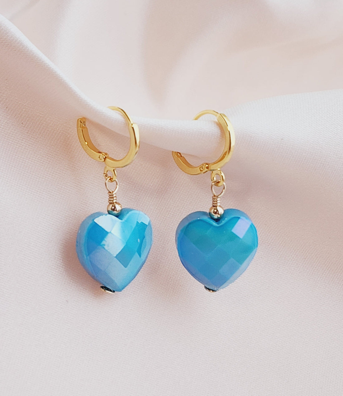 Front view baby blue faceted heart earrings hoops