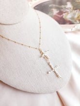 Top view of a lariat necklace with handmade pearl crosses dangling in the center, perfect necklace for everyday and bridal 