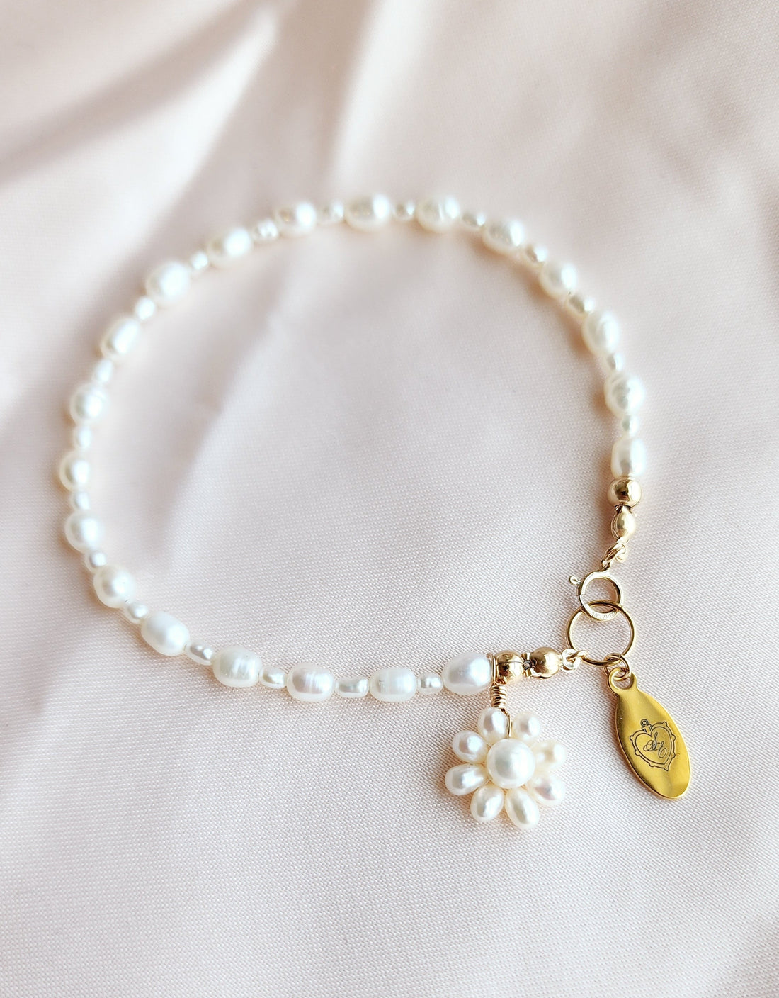 Top View of a beaded pearl bracelet with a pearl beaded flower