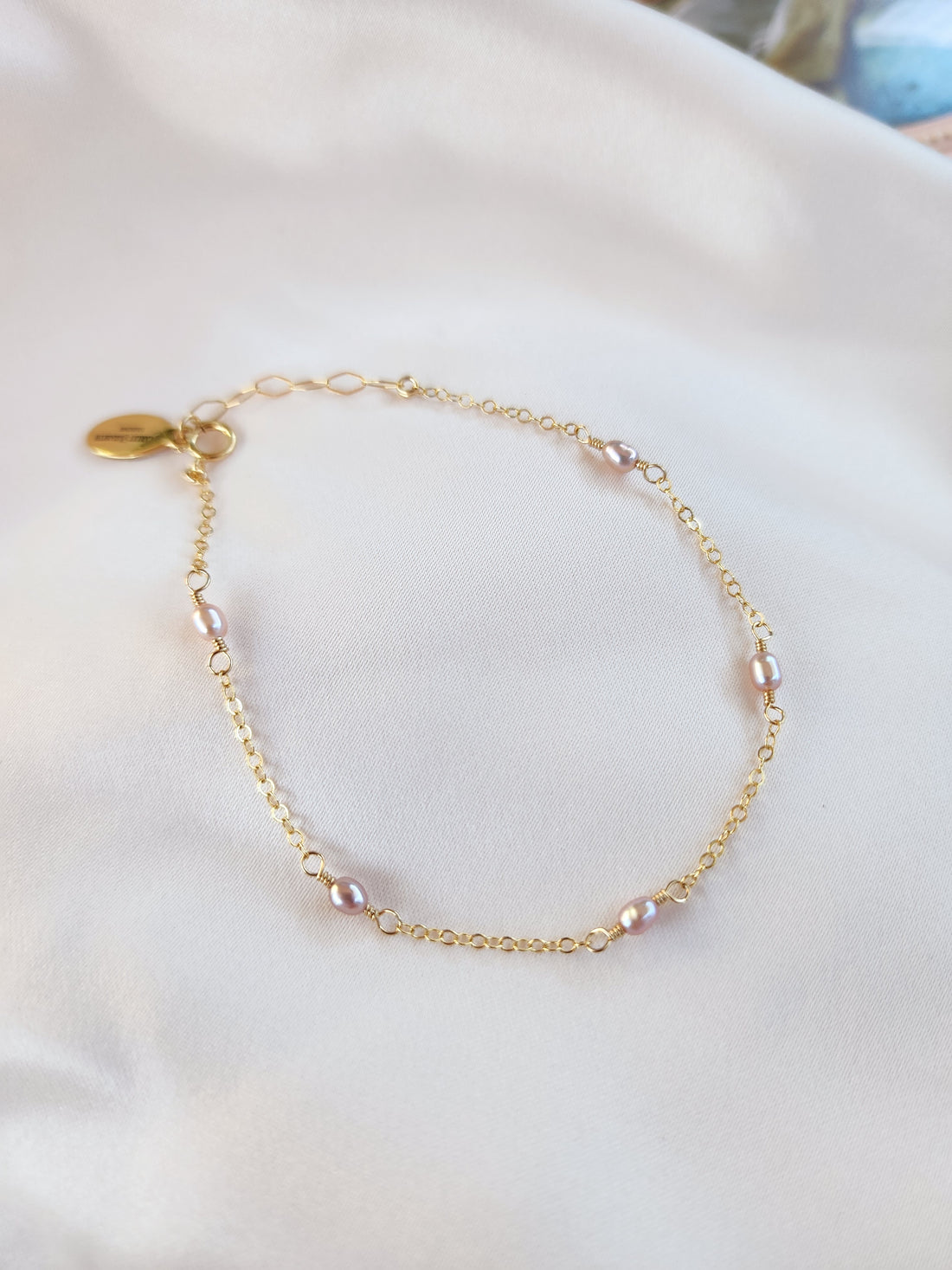 Top View Beautiful pink pearl linked chain bracelet in gold and sterling silver