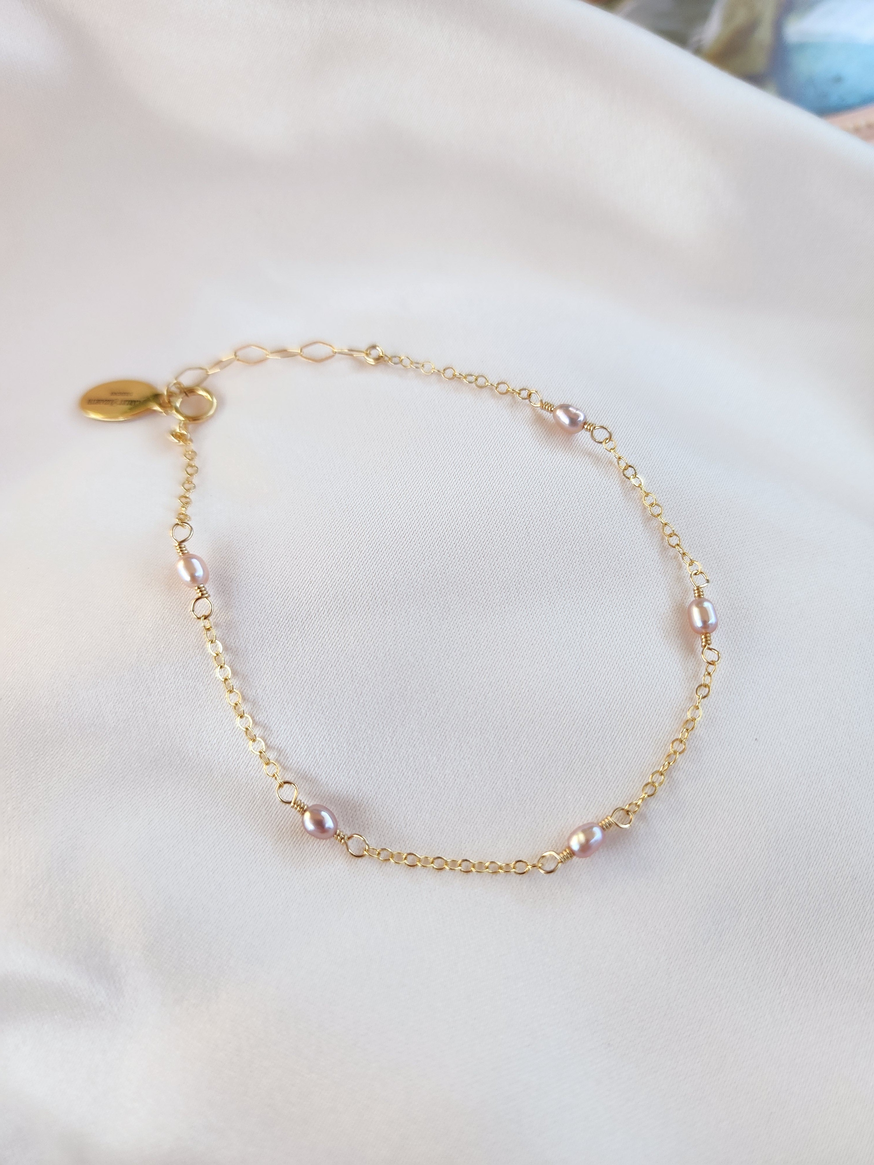 Top View Beautiful pink pearl linked chain bracelet in gold and sterling silver