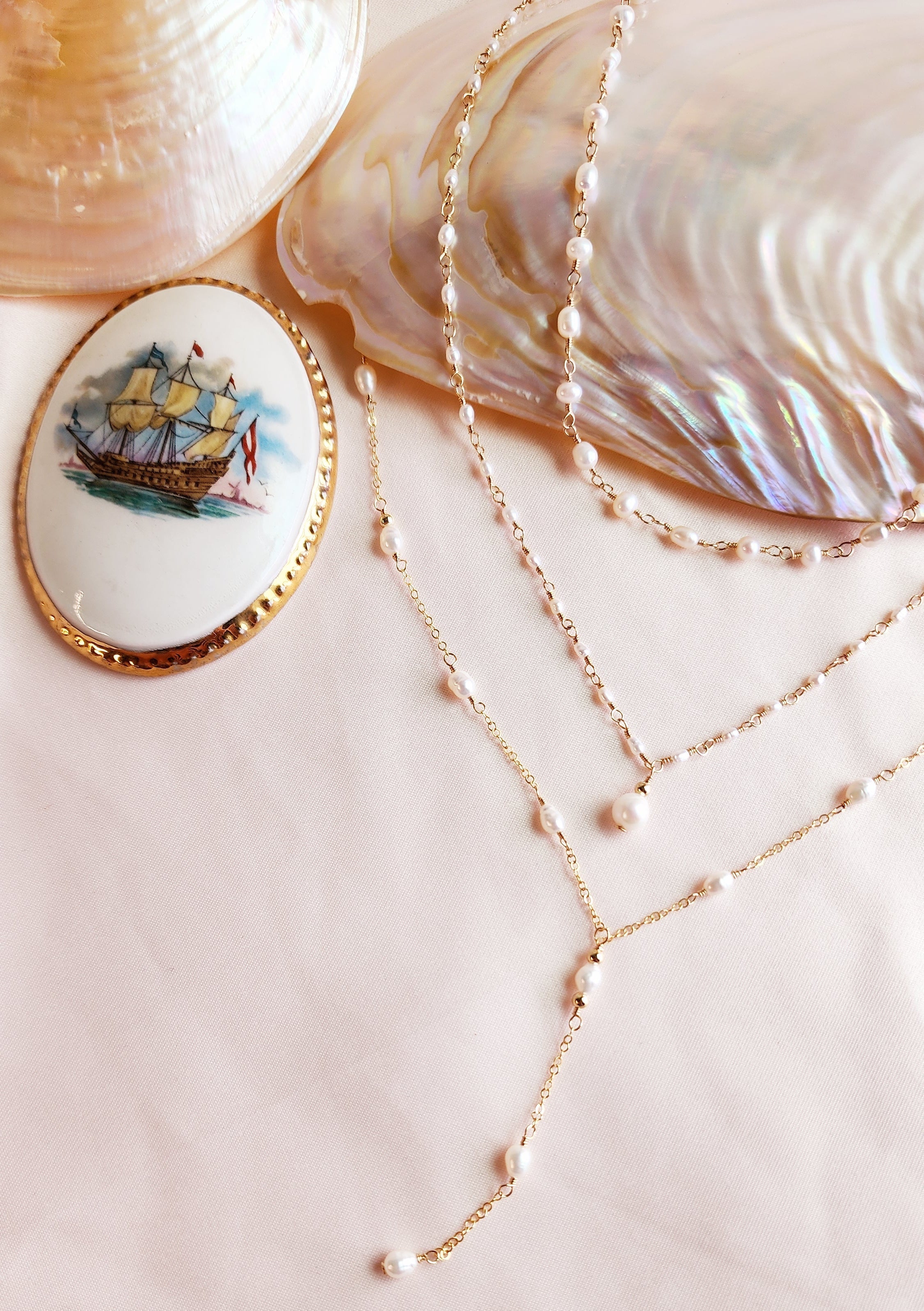 Top View of styled layered necklaces with pearls and 14kt gold fill chain. Romantic necklaces, rosary style necklaces