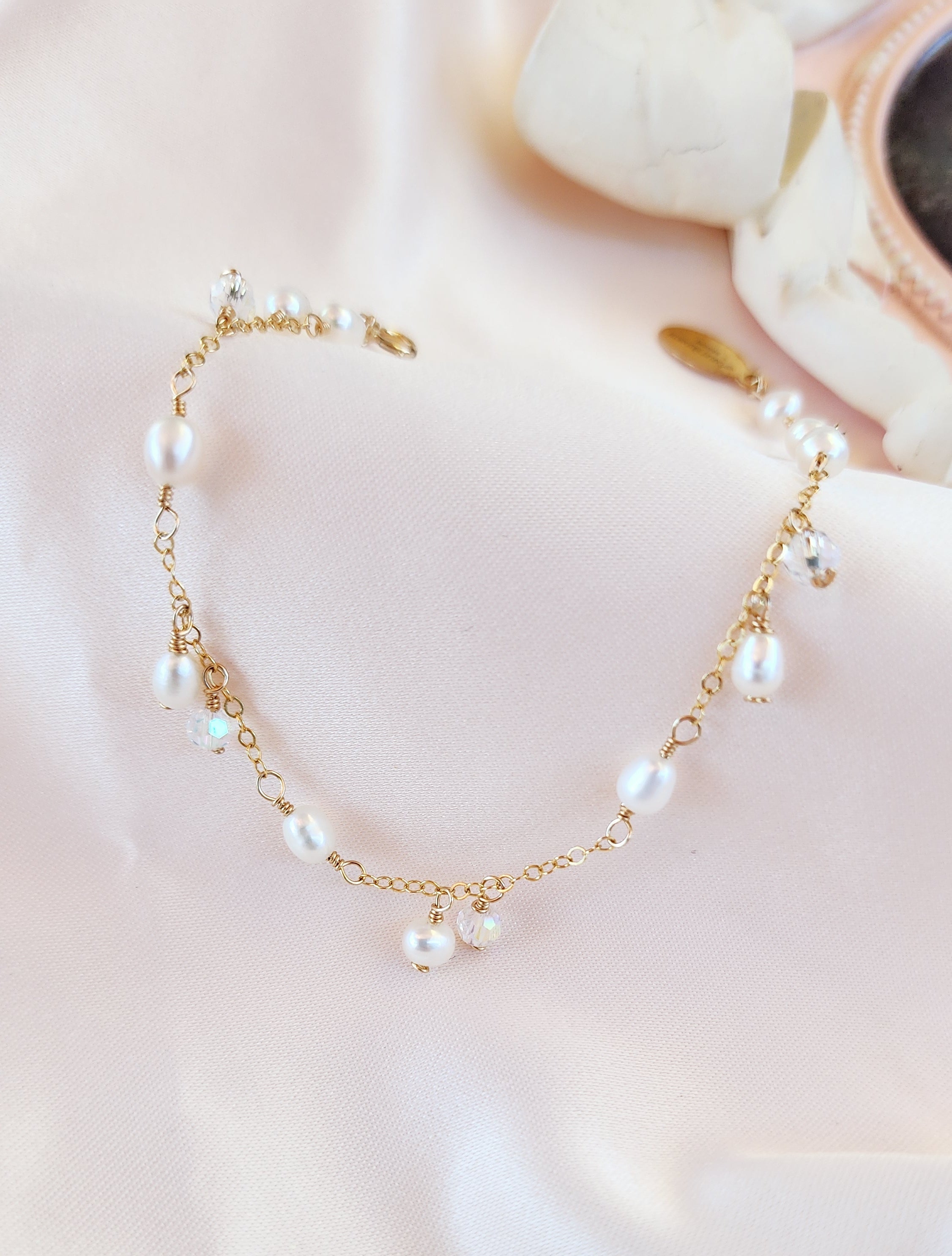 Top View dainty pearl and dangling crystal bracelet for brides and everyday women