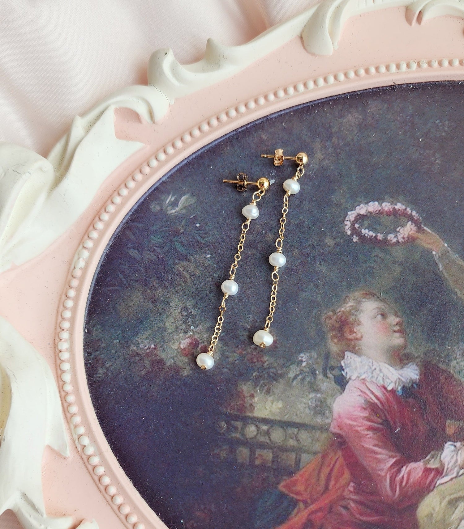 Top View Beautiful pearl dangly stud earrings for a bride and everyday client that wants dainty medium length earrings
