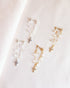 Romantic stud earrings with layering of crystals for a dreamy, dramatic feel with a dangling cross charm 